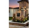 Close-up of the unique brickwork address marker with beautiful floral accents at 8233 E Hubbell St, Scottsdale, AZ 85257