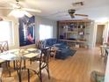 Open-concept living room with wood floors, a ceiling fan, and natural light at 8600 E Broadway Rd # 22, Mesa, AZ 85208