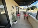 Relaxing covered patio featuring comfortable seating and views of the surrounding desert landscape at 877 E Lancaster Cir, Florence, AZ 85132