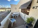 Charming front patio area with seating, decorative accents, and a sunshade for added comfort at 877 E Lancaster Cir, Florence, AZ 85132