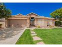 Charming single-story home featuring desert landscaping, stone accents, and a two-car garage at 9420 E Plata Ave, Mesa, AZ 85212