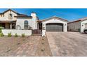 Charming single-story home exterior featuring a cobblestone driveway, brown garage door, and desert landscaping at 9742 W Los Gatos Dr, Peoria, AZ 85383