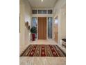 Bright foyer with high ceilings, natural light, and a decorative rug at 9904 E Lookout Mountain Dr, Scottsdale, AZ 85262