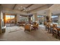 Spacious living room with wood-beamed ceilings, fireplace, and sliding glass doors to the patio at 9904 E Lookout Mountain Dr, Scottsdale, AZ 85262