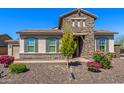 Beautiful home exterior with desert landscaping and stone accents at 10110 W El Cortez Pl, Peoria, AZ 85383