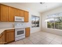 Cozy eat-in kitchen features tile flooring, white appliances, and lots of natural light at 10588 E Tierra Buena Ln, Scottsdale, AZ 85255