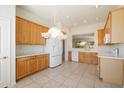 Spacious kitchen with tile floors and white appliances and ample cabinetry at 10588 E Tierra Buena Ln, Scottsdale, AZ 85255