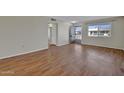 Spacious living room with wood floors and bright natural light at 13808 N Silverbell Dr, Sun City, AZ 85351