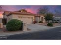 Charming single-story home featuring a tile roof, desert landscaping, and a two-car garage at 15145 W Catalina Dr, Goodyear, AZ 85395