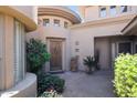 Inviting front entrance features a unique turret design, lush greenery and desert landscaping at 15240 N Clubgate Dr # 162, Scottsdale, AZ 85254