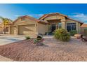 Charming single-story home with desert landscaping, a tile roof, and a three-car garage under a blue sky at 1710 W Winchester Way, Chandler, AZ 85286