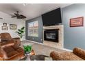 Inviting living room featuring a stone fireplace, neutral carpet, and comfortable seating at 1710 W Winchester Way, Chandler, AZ 85286