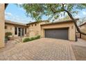 Exterior view of house featuring an oversized two-car garage and paved driveway at 17727 N 95Th Pl, Scottsdale, AZ 85255