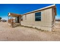 Side exterior view of the mobile home with porch at 19954 W Teepee Rd, Buckeye, AZ 85326