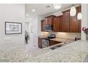 Kitchen with granite countertops, stainless steel appliances and wood cabinetry at 21232 N 262Nd Dr, Buckeye, AZ 85396