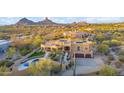 Stunning aerial view of a luxury home with solar panels and desert landscaping at 24200 N Alma School Rd # 4, Scottsdale, AZ 85255