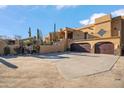 Gorgeous southwestern home featuring a three-car garage and desert landscaping at 24200 N Alma School Rd # 4, Scottsdale, AZ 85255