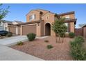 Beautiful two-story home with a two-car garage and desert landscaping featuring decorative gravel and native plants at 25451 N 164Th Dr, Surprise, AZ 85387