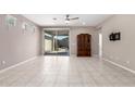 Open living room features tiled flooring and sliding glass doors to the backyard at 3235 W Carter Rd, Phoenix, AZ 85041