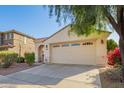 Charming single-story home featuring a two-car garage, desert landscaping, and a welcoming entryway at 3890 S Star Canyon Dr, Gilbert, AZ 85297