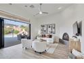 Bright living room with modern fireplace and doors leading to a luxury pool area at 42038 N Moss Springs Rd, Anthem, AZ 85086