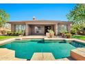 Stunning backyard pool and patio with lush greenery and a covered outdoor space at 5206 S Fairchild Ln, Chandler, AZ 85249