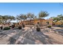 Attractive home with desert landscaping, featuring a private gated courtyard and mature trees at 6915 E Gary Rd, Scottsdale, AZ 85254