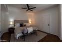 Cozy bedroom featuring a ceiling fan, neutral tones, and a decorative rug over wood floors at 7209 E Mcdonald Dr # 51, Scottsdale, AZ 85250