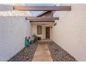 View of a quaint, private entryway with a stone walkway leading to the front door at 7721 E Valley Vista Ln, Scottsdale, AZ 85250