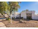 Attractive single-story house with a xeriscaped front yard featuring desert plants and minimal grass at 7721 E Valley Vista Ln, Scottsdale, AZ 85250