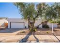 Street view of a well-maintained single-story home with a mature tree in the landscaped front yard at 7721 E Valley Vista Ln, Scottsdale, AZ 85250