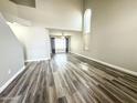 Bright living room featuring high ceilings, modern flooring, and large windows at 8437 W Bluefield Ave, Peoria, AZ 85382