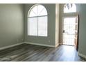 Well-lit room features a striking arched window and modern flooring at 8437 W Bluefield Ave, Peoria, AZ 85382