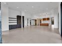 Spacious living room with open layout, featuring recessed lighting and access to kitchen and hall at 10354 E Celestial Dr, Scottsdale, AZ 85262
