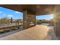 Covered patio with built-in fireplace, offering an inviting outdoor space for relaxation and entertaining at 10354 E Celestial Dr, Scottsdale, AZ 85262