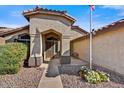 Inviting home entrance with desert landscaping and a charming covered porch area at 10778 W Via Del Sol --, Peoria, AZ 85373