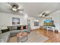 Bright living room with a comfortable gray sofa, stylish decor, and wood-look flooring at 10778 W Via Del Sol --, Peoria, AZ 85373