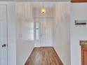 Inviting entryway featuring wood-look floors, a coat rack, and a view of the front door at 108 W Ivyglen St, Mesa, AZ 85201