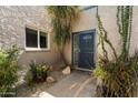 Cozy home entrance with desert landscaping, a secure screen door, and a tiled walkway at 1173 E Beryl Ave, Phoenix, AZ 85020