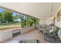 Spacious covered patio with outdoor seating, offering tranquil views of the golf course and landscape at 1202 Leisure World --, Mesa, AZ 85206