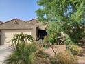 Well-manicured front yard with desert landscaping and an attached two-car garage at 1280 W Blue Ridge Dr, San Tan Valley, AZ 85140