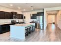 Bright, open kitchen with a granite island, stainless appliances, and dark cabinets at 1280 W Blue Ridge Dr, San Tan Valley, AZ 85140