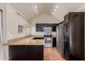 Modern kitchen featuring stainless steel appliances, granite countertops, and dark cabinetry, enhancing the home's appeal at 1633 E Lakeside Dr # 106, Gilbert, AZ 85234