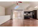 Spacious living area featuring vaulted ceilings, wood flooring, and sliding glass doors leading to outdoor space at 1633 E Lakeside Dr # 106, Gilbert, AZ 85234