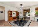 Open dining area with modern chandelier and sliding door access to outdoor patio and beautiful landscaping at 16564 W Wild Horse Way, Surprise, AZ 85387