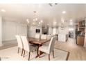 Bright dining area features a wooden table with seating for six, chandelier lighting and an open floorplan at 1838 E Crocus Dr, Phoenix, AZ 85022