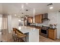 Spacious kitchen features stainless steel appliances, a white tile backsplash, and a large island with bar seating at 1838 E Crocus Dr, Phoenix, AZ 85022