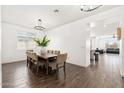 Bright dining area with an elegant chandelier and seating for eight people at 19181 W Jackson St, Buckeye, AZ 85326