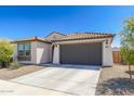 Attractive single-story home with a tile roof, two-car garage and a well-kept front yard at 19181 W Jackson St, Buckeye, AZ 85326