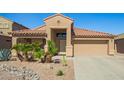 Charming single-story home with desert landscaping, tile roof, and two-car garage at 22499 N Dietz Dr, Maricopa, AZ 85138